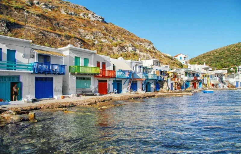 Colourful boathouse doors along the water in the fishing village of Klima on Milos