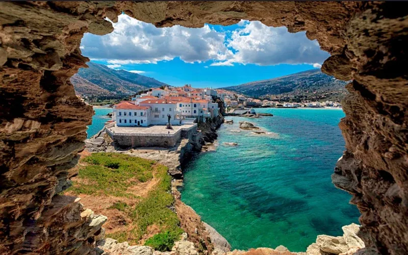 Andros town on its narrow headland, framed by an opening in the rocks