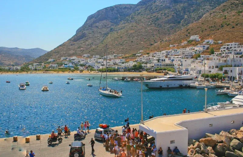 Yachts anchored off the harbour quay on Sifnos, a stop when island hopping in the Cyclades