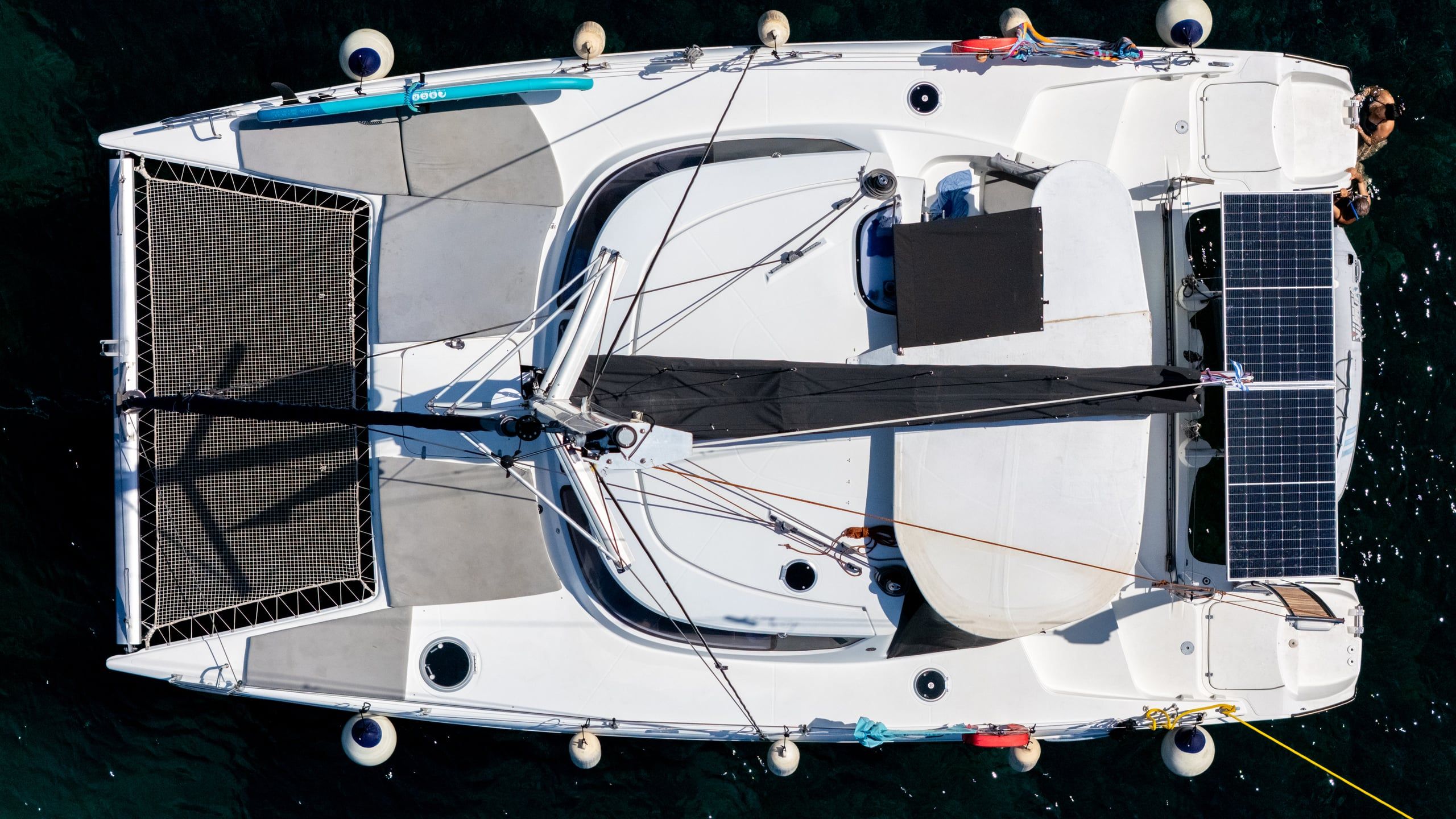 Catamaran at anchor at Agia Kyriaki with its trampoline nets, seen from directly above