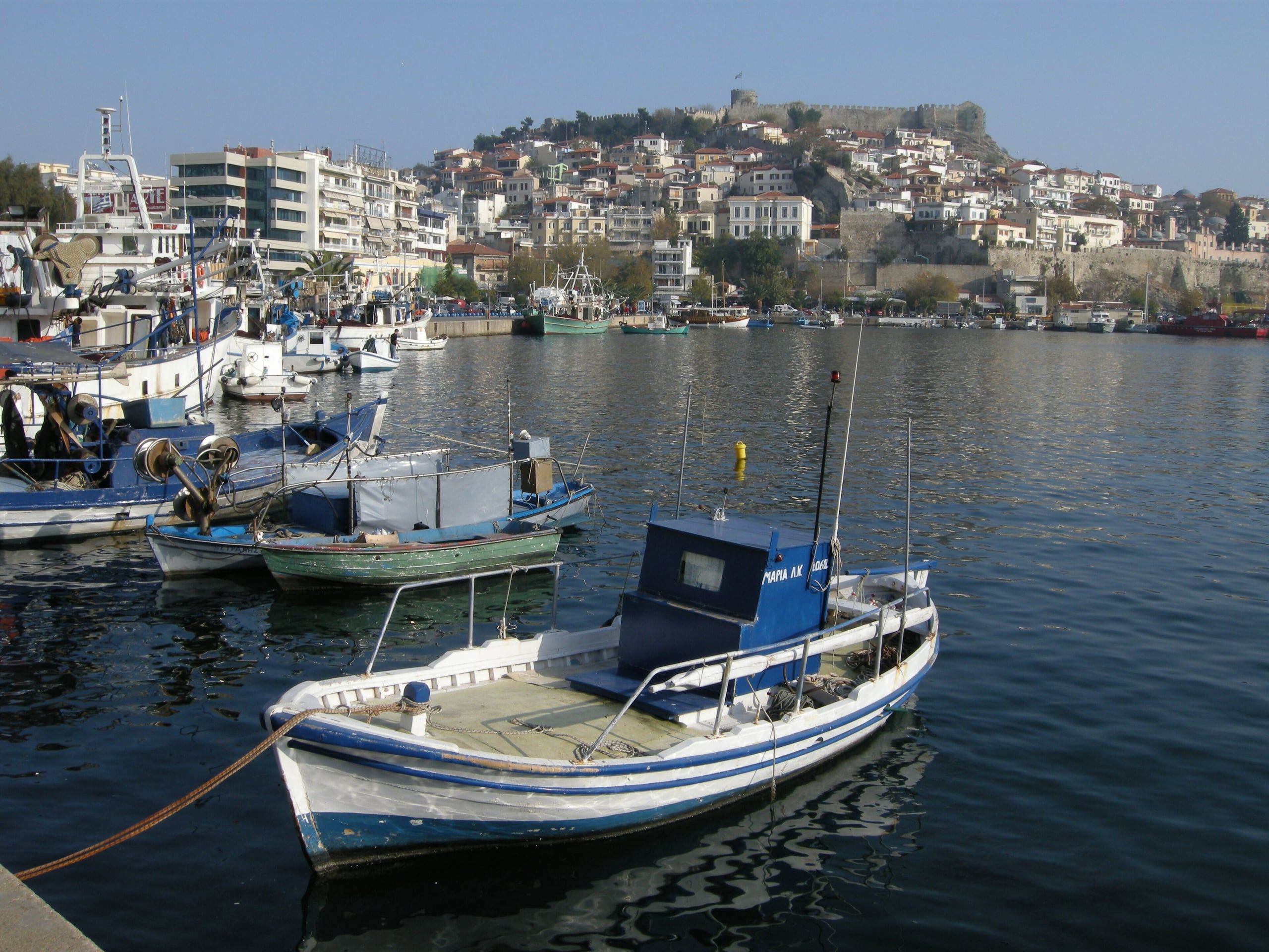 Fishing boats in Kavala harbour with the old town and castle behind