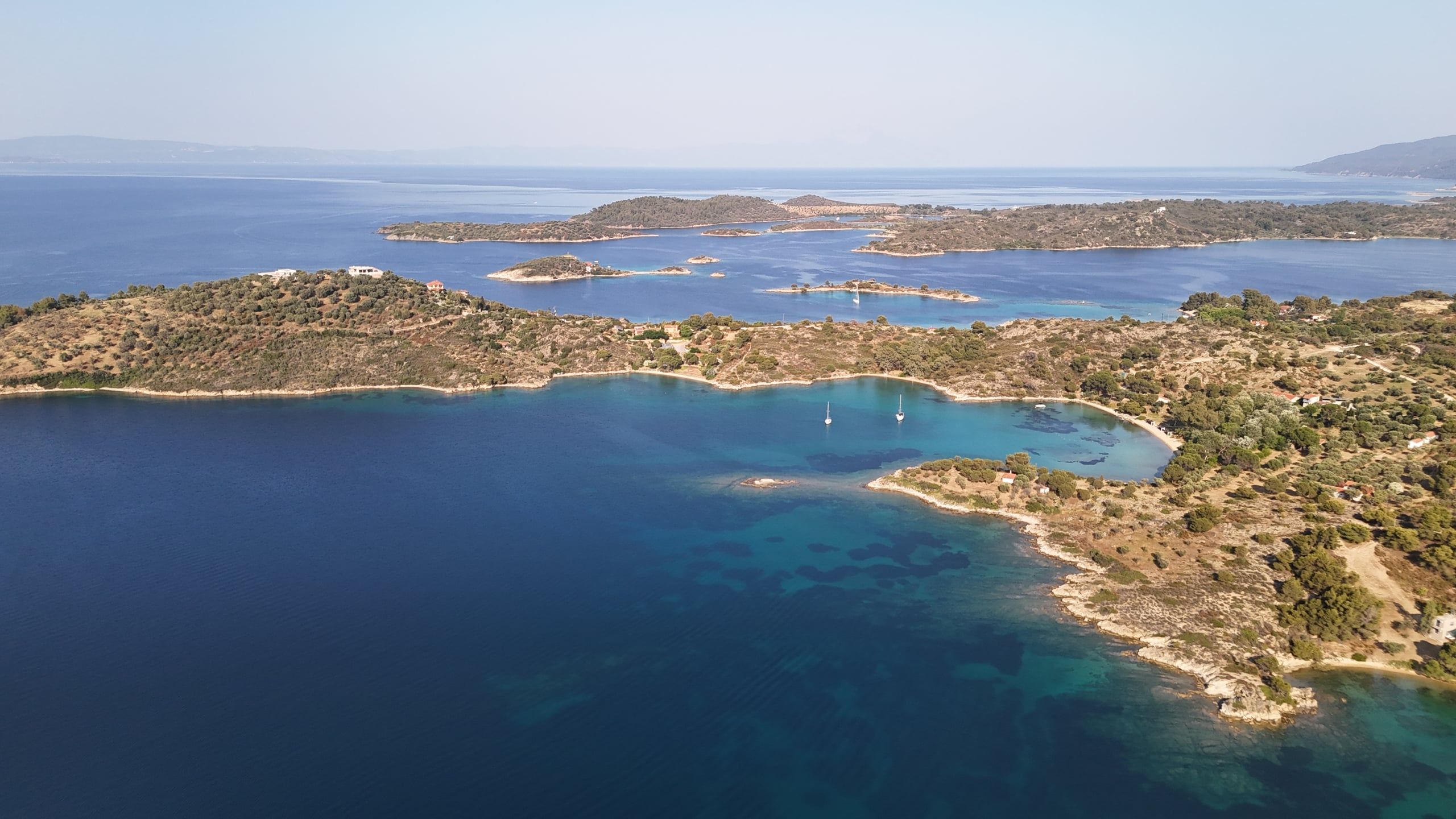 Wooded islets and quiet bays along the coast at Lagonisi, seen from above
