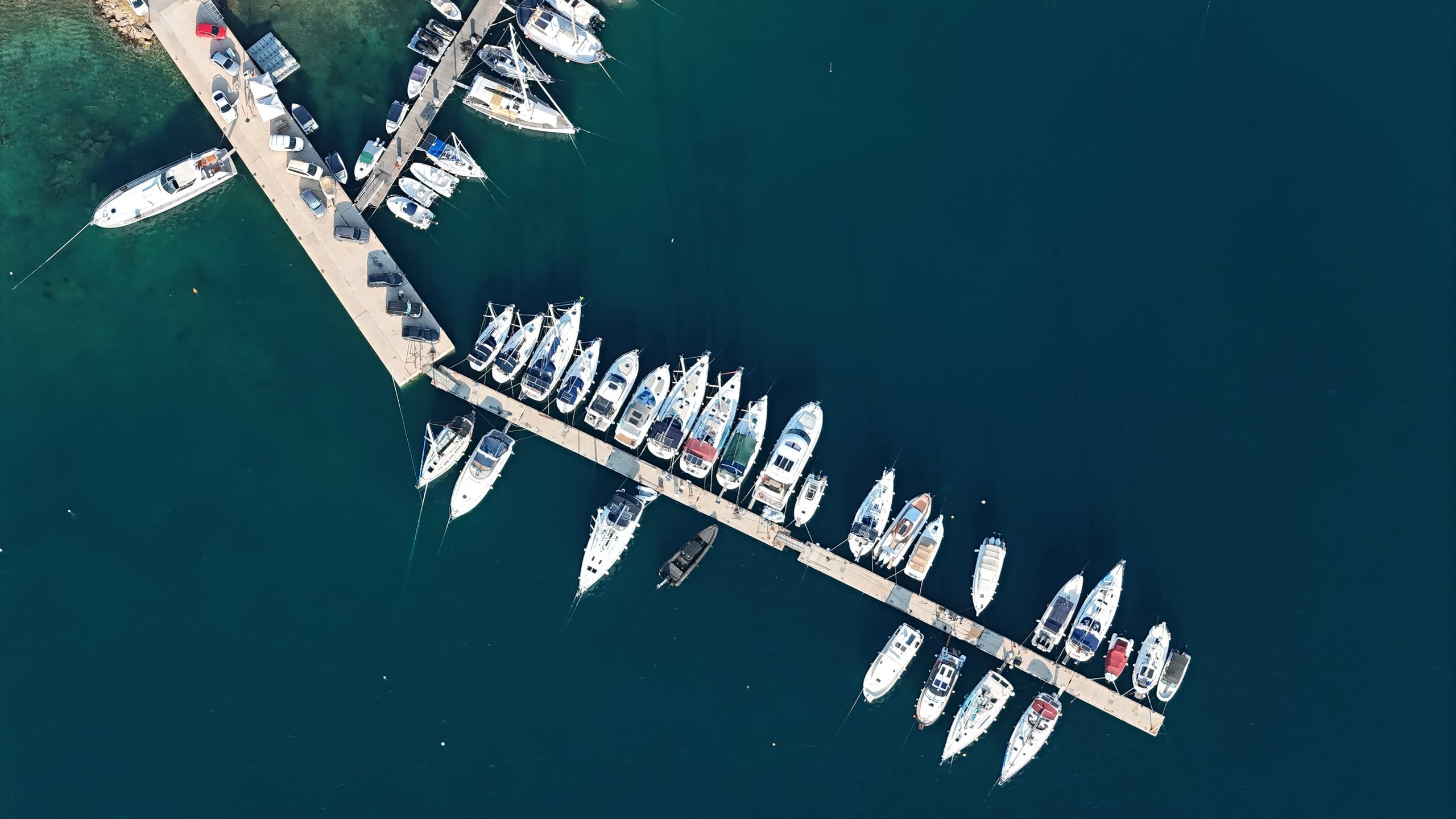 Boats moored along the pontoons of Marina Latoura, seen from above