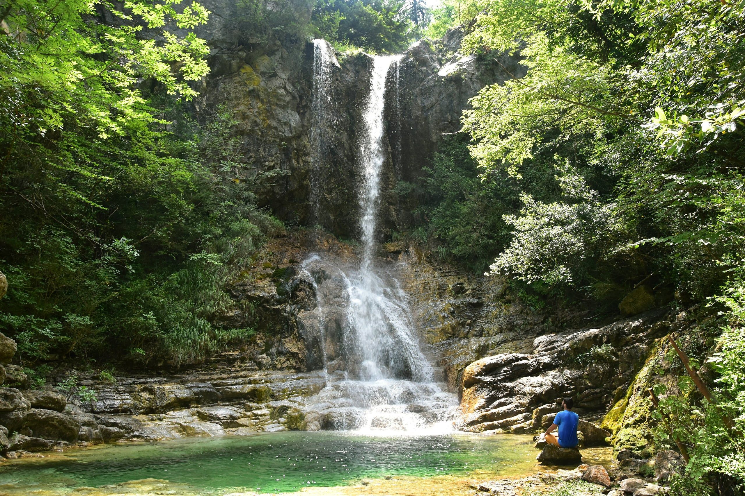 Waterfall dropping into a green pool in the Orlias Gorge on Mount Olympus