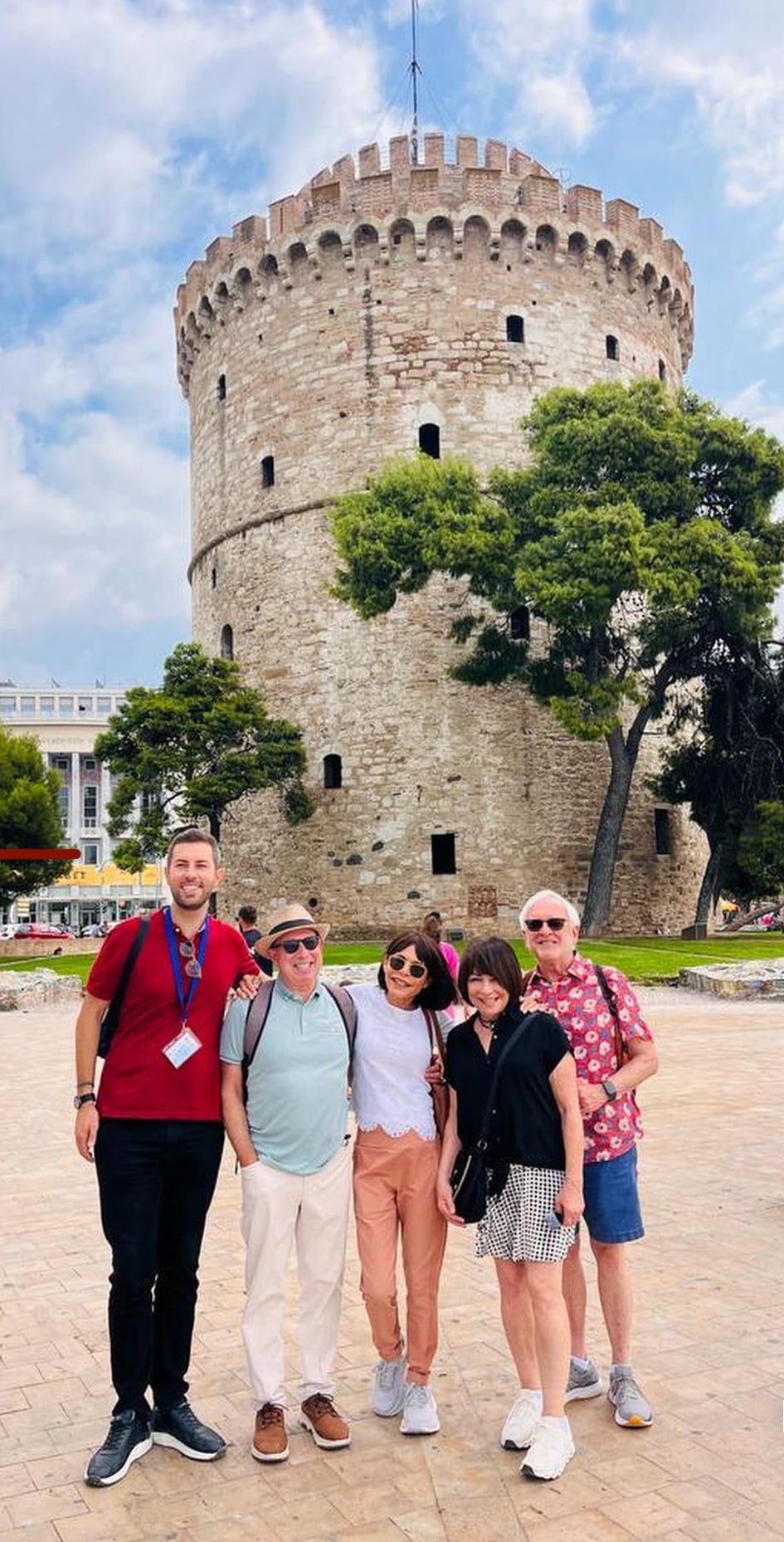 Small group of visitors standing in front of the White Tower in Thessaloniki
