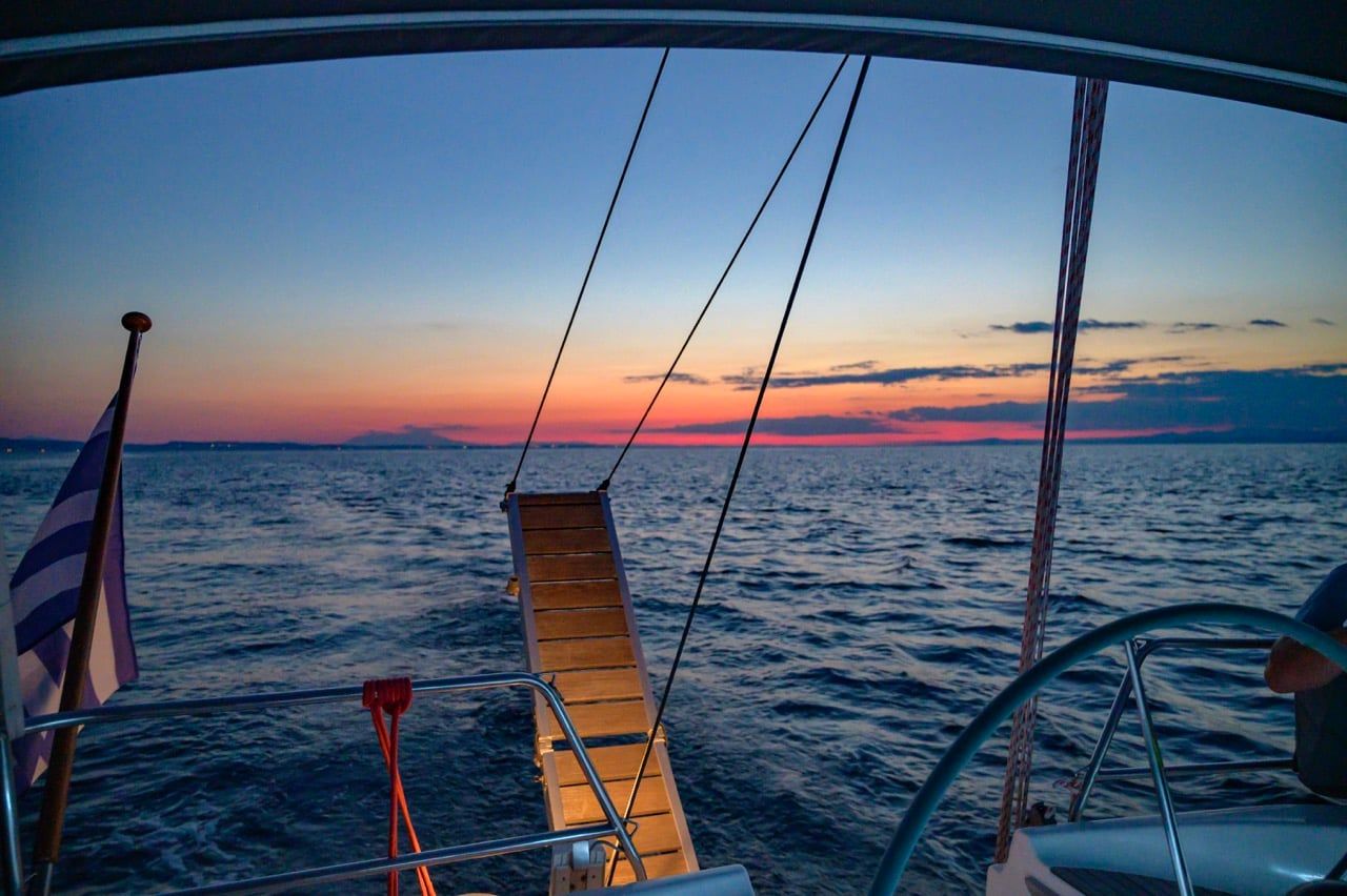 Swim ladder and wake at a sailing yacht’s stern at dusk